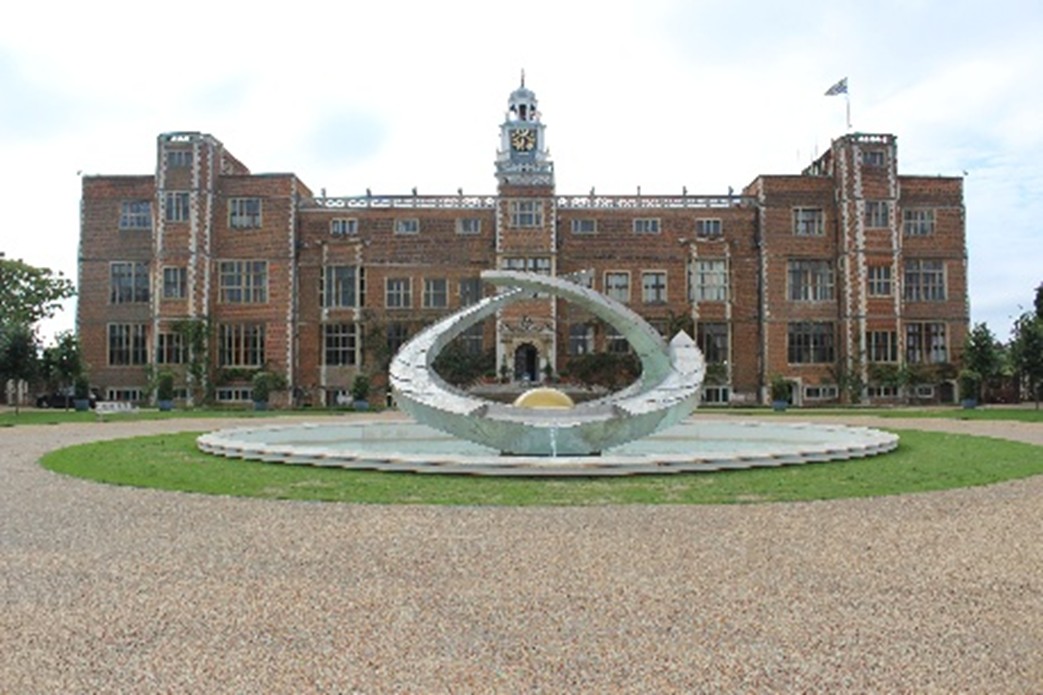 Sculpture in front of large house