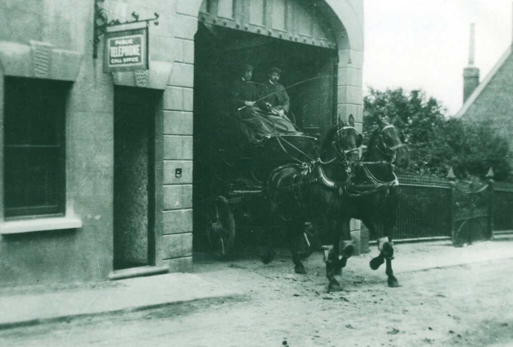 Two horses and cart with men